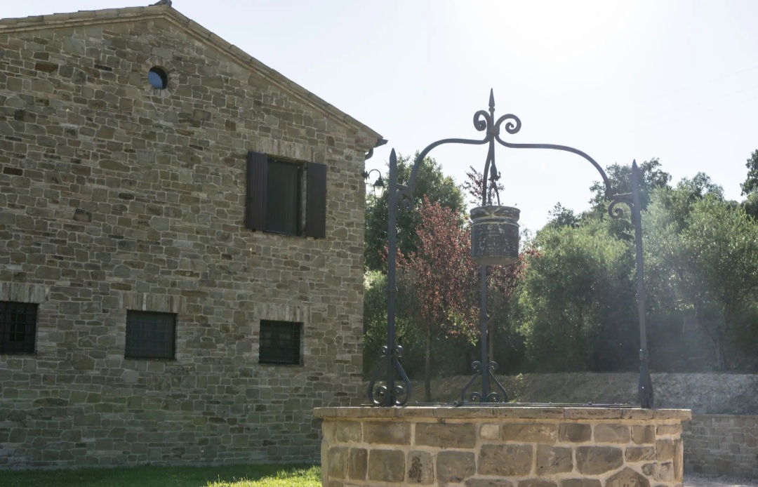 Casale in pietra di Villa La Torre con pozzo in ferro battuto